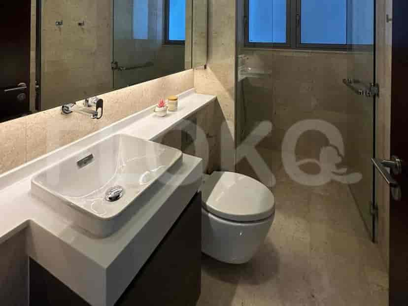 A modern bathroom featuring a vanity, toilet, and a shower area.