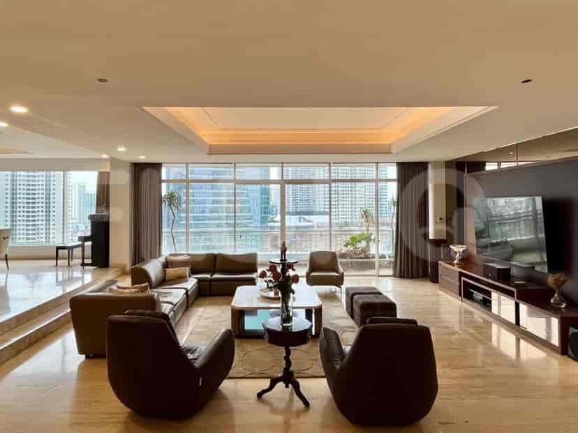 A grand living room with a sectional sofa, armchairs, a coffee table, a piano, and a large window overlooking the city.