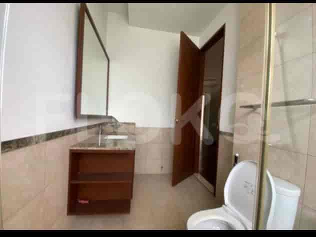 A bathroom with a vanity, a mirror, and a western-style toilet.