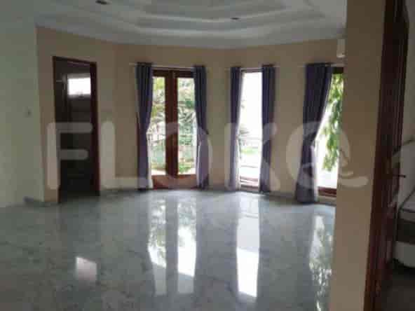 An empty living room with large windows, marble floors, and curtained doors.