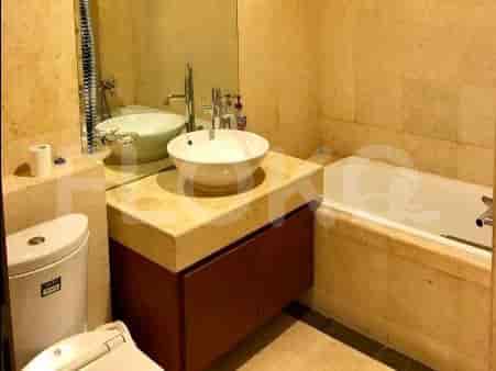 A bathroom with a bathtub, a sink with a vanity, and a toilet.