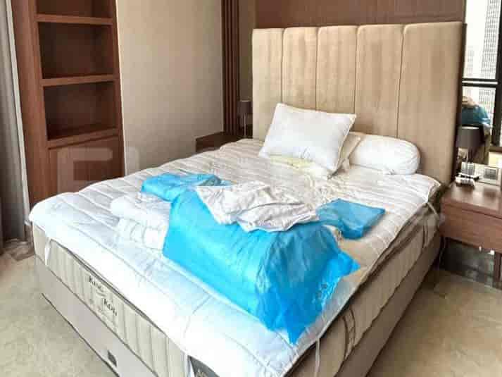 A bedroom with a king-size bed, nightstands, and a tall bookshelf.