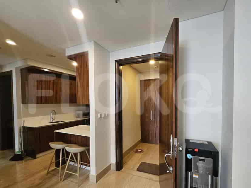 Open-plan kitchen with breakfast bar and access to bedrooms.