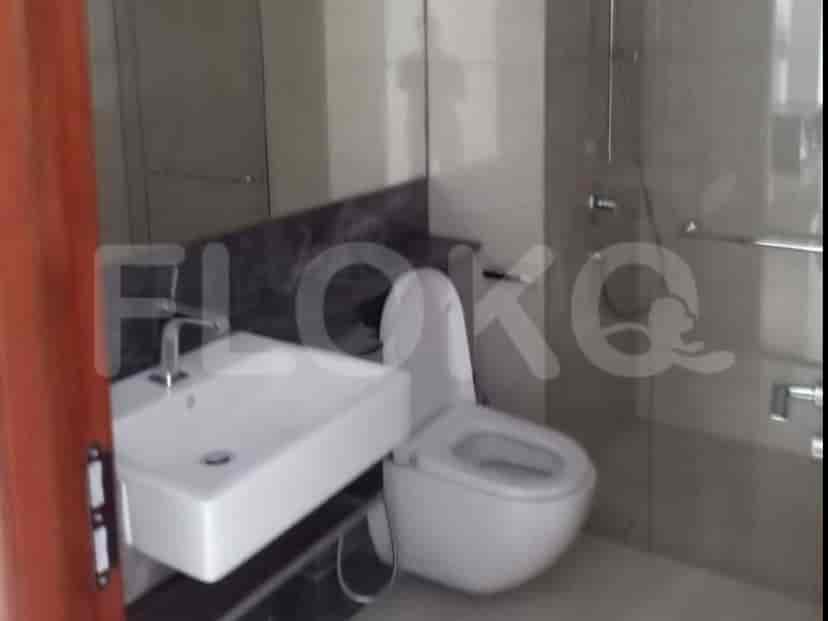 A bathroom with a shower, a sink and a toilet.