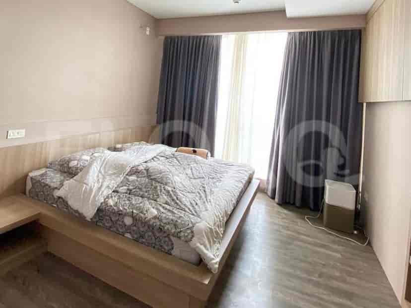 Bedroom with a bed, curtains, and a window.