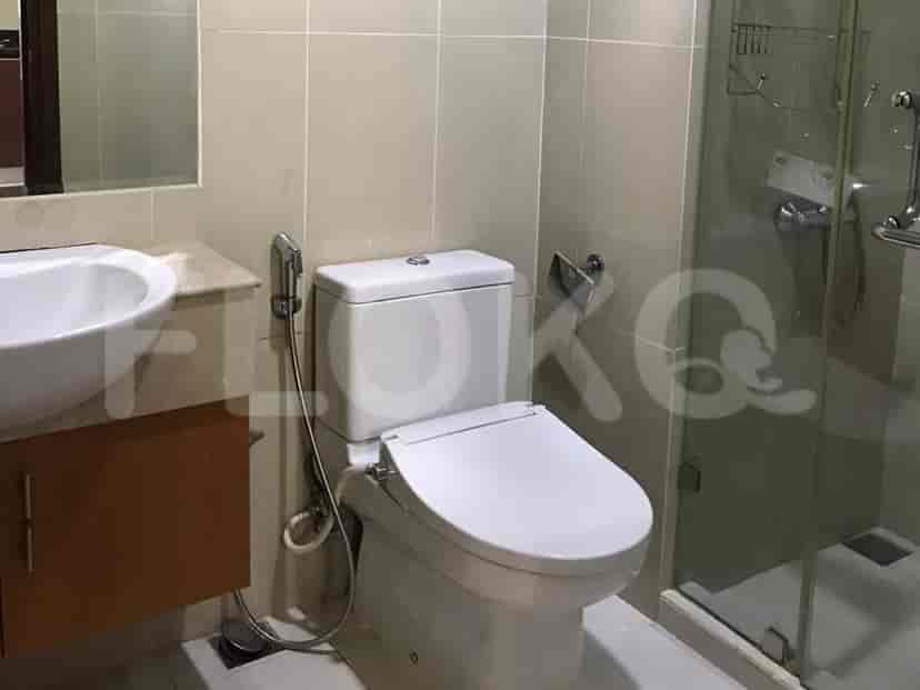 A bathroom with a toilet, sink, and shower stall.