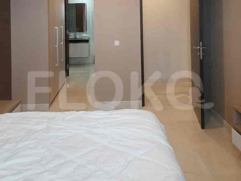 Bedroom interior with a bed, wardrobe, and a doorway leading to another room.