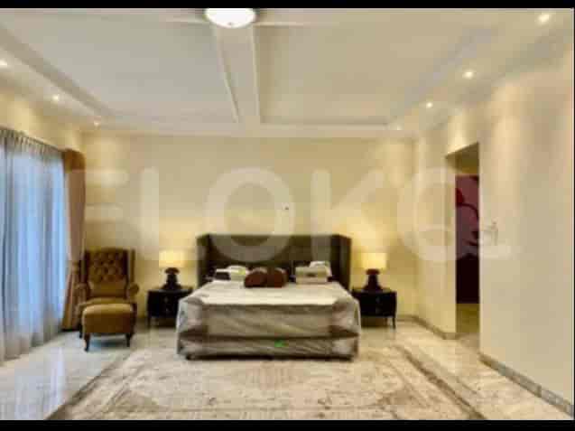 A master bedroom featuring a large bed, two nightstands with lamps, and a luxurious carpet.