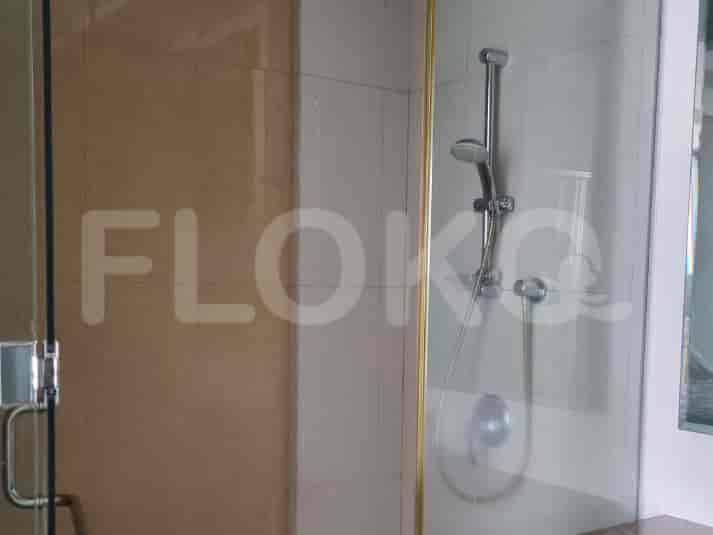 Shower with glass enclosure and a shower head.