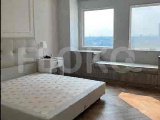 Cozy bedroom with a comfortable bed, a nightstand, and a large window.