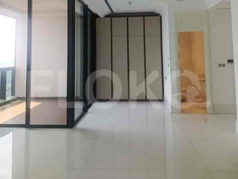 A modern hallway with white marble flooring, a large built-in wardrobe, and a doorway leading to a bathroom.