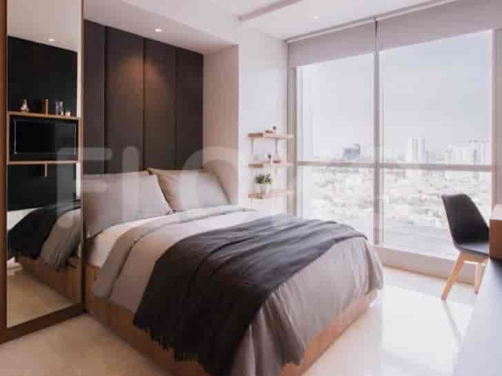 A cozy bedroom with a large bed, a headboard, a mirrored wardrobe, and a city view from the window.
