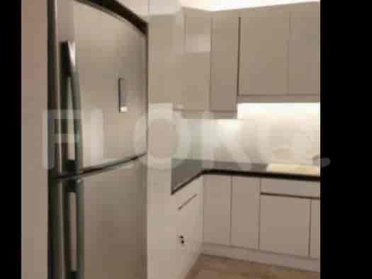 A modern kitchen with white cabinets and a stainless steel refrigerator.