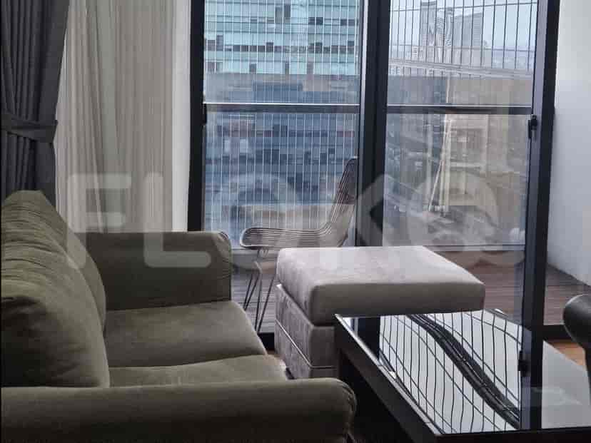 Living room featuring a grey sofa, coffee table, and a view of the city.