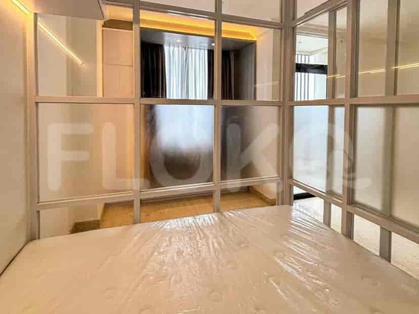 Bedroom with a bed, glass dividers and closet.