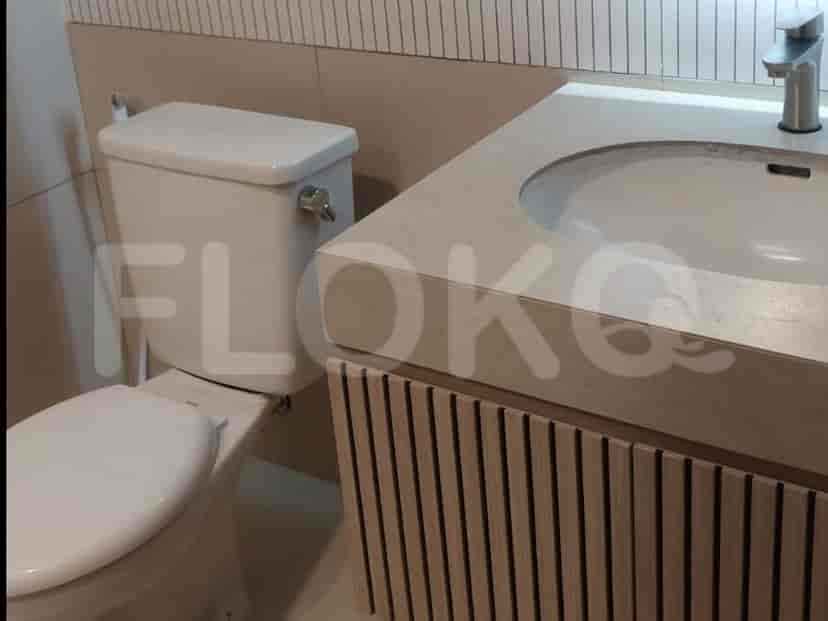 Bathroom with a toilet and a vanity with a sink.
