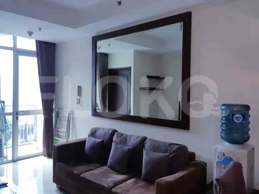A living room featuring a TV console, a flat-screen TV, and shelves.
