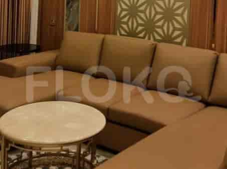 A modern living room with a brown leather sofa and a marble table.