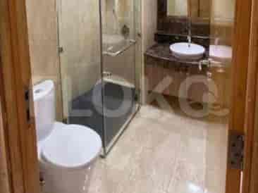 A modern bathroom featuring a glass-enclosed shower, a toilet, and a vanity.