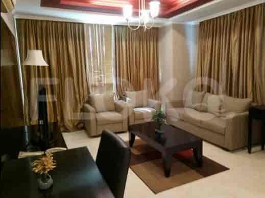 A living room featuring a sofa, armchair, coffee table, and floor lamp.