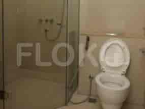A bathroom with a shower and toilet.