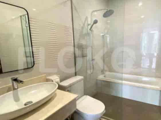 A modern bathroom with a bathtub, shower, and a vanity.