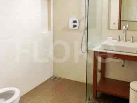 A modern bathroom with a glass-enclosed shower, a vanity unit, and a toilet.