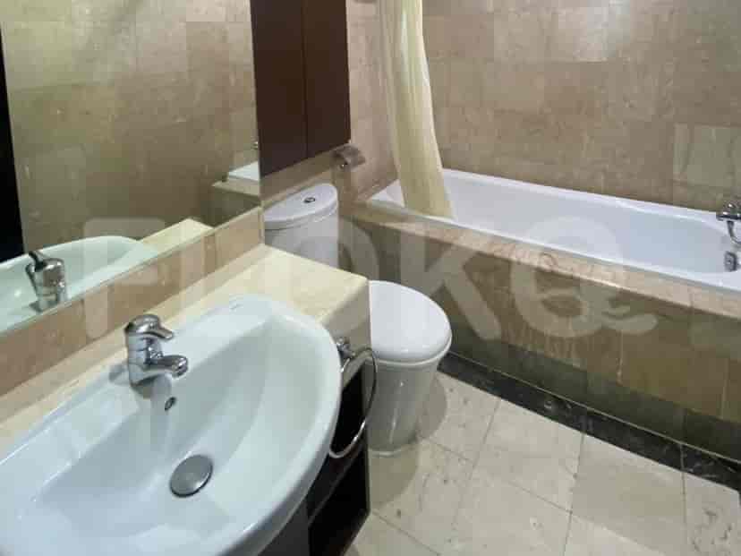 A bathroom with a bathtub, toilet, and sink.