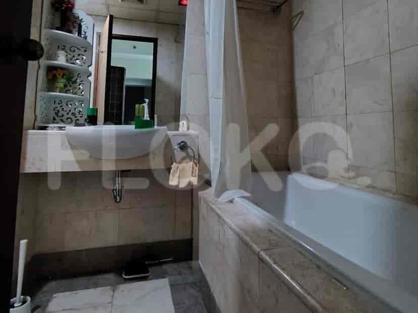 A bathroom with a bathtub, sink, vanity, and mirror.