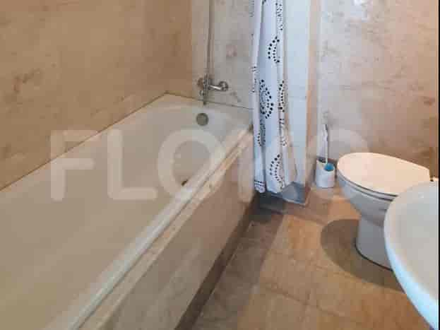 A bathroom with a bathtub and a toilet.