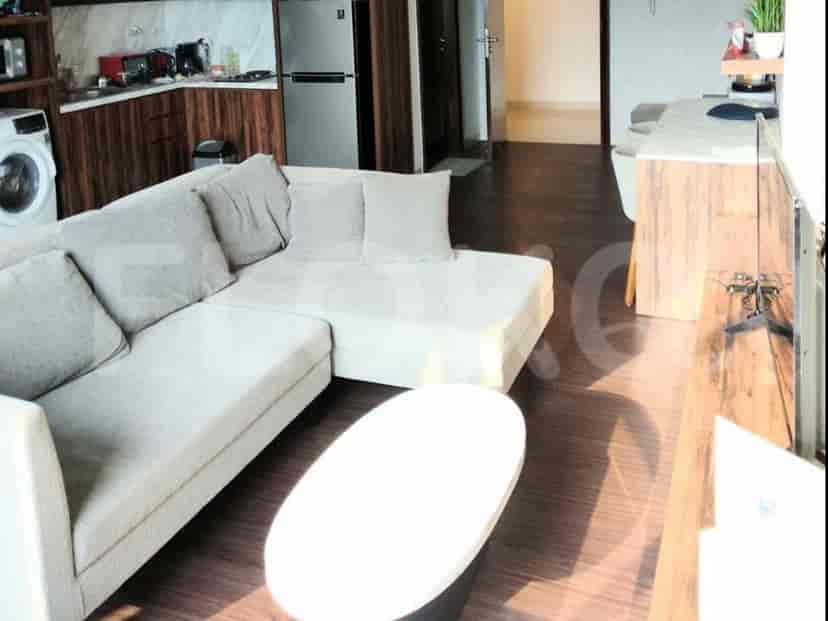 Ruang tamu modern dengan sofa berbentuk L besar dan meja kopi kecil.