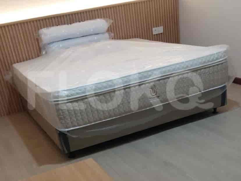 Bedroom with a queen-sized bed and wooden headboard.