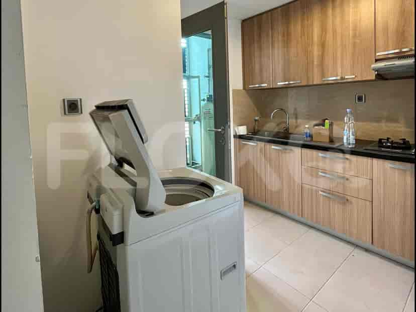 Kitchen and Laundry space featuring a washing machine, cabinets, and counter.