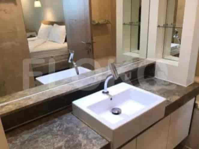 A modern bathroom featuring a white sink and mirror.