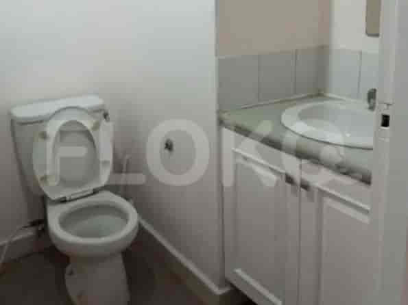 A bathroom with a toilet, sink, and vanity.