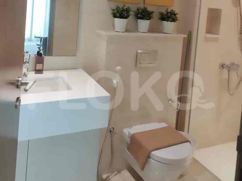 Modern bathroom with a sink, toilet, and shower.
