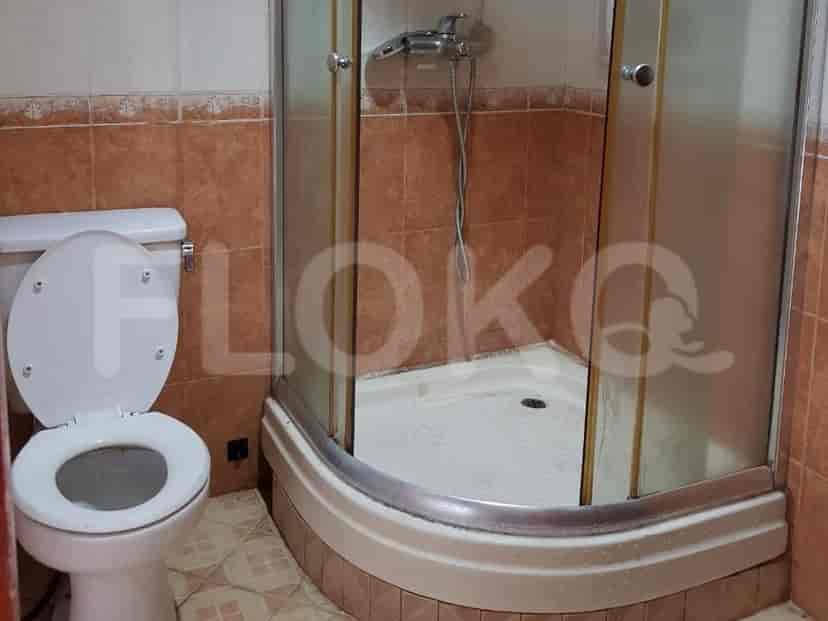 A small bathroom featuring a shower and toilet.