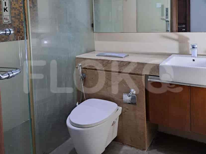 Bathroom with a toilet, sink, and shower.