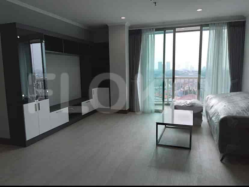 Spacious living room with large windows, a coffee table, and a neutral color palette.
