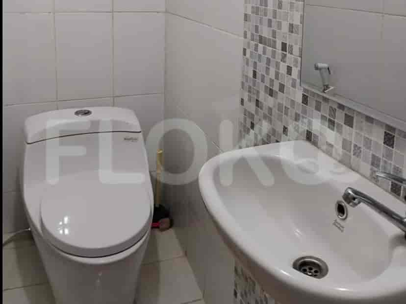 A modern bathroom with a toilet and sink.