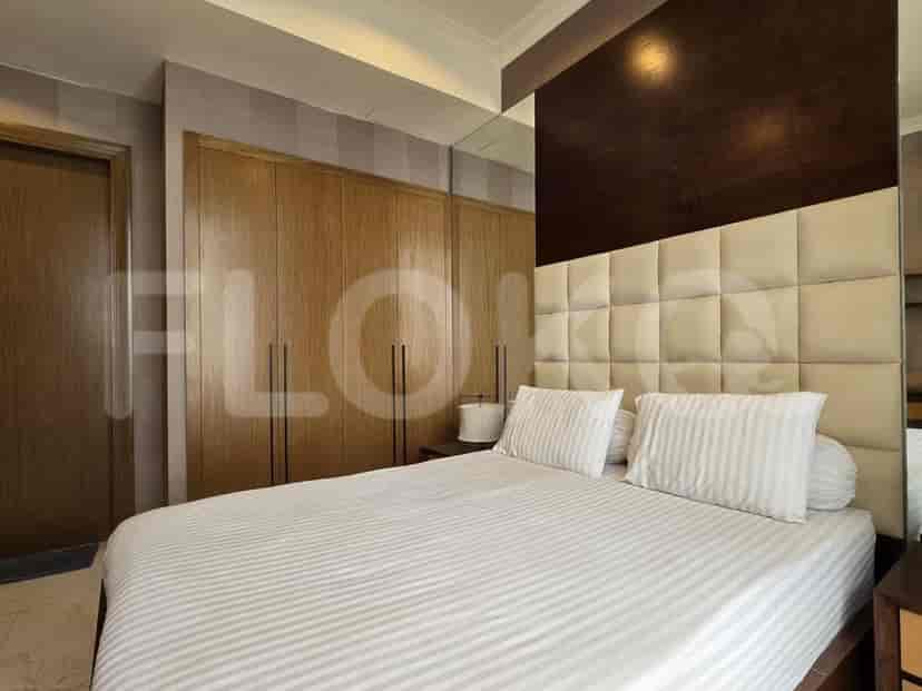 Bedroom with a large bed, closet, and a neutral color scheme.