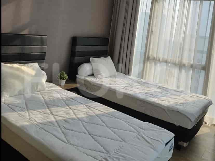 A second bedroom with two single beds and an elegant interior.