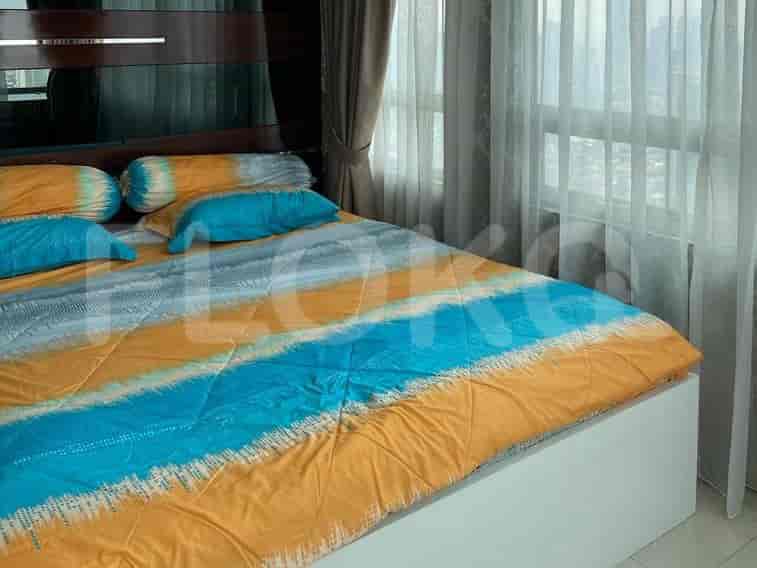 Bedroom with a bed and a large window.