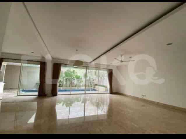 An open living space with polished marble flooring, expansive windows overlooking a pool and garden, and a high ceiling.