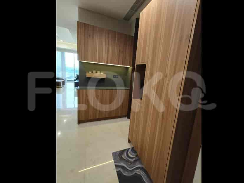 A hallway with wooden paneling and a built-in cabinet.