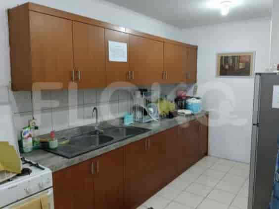 A kitchen showcasing wooden cabinets, stainless steel sink and gas stove.