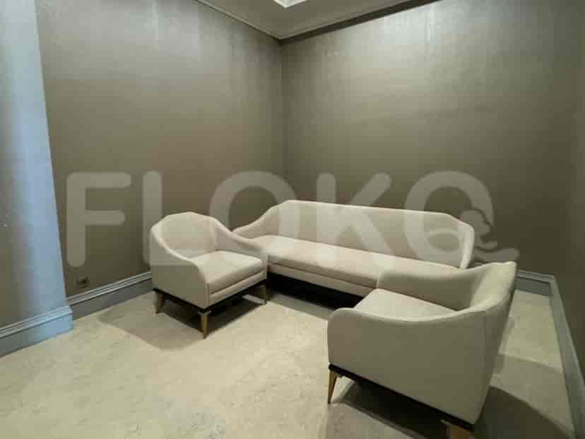 A lounge area with a sofa and armchairs.