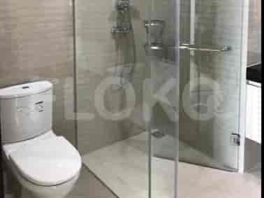 A modern bathroom featuring a glass shower and a toilet.