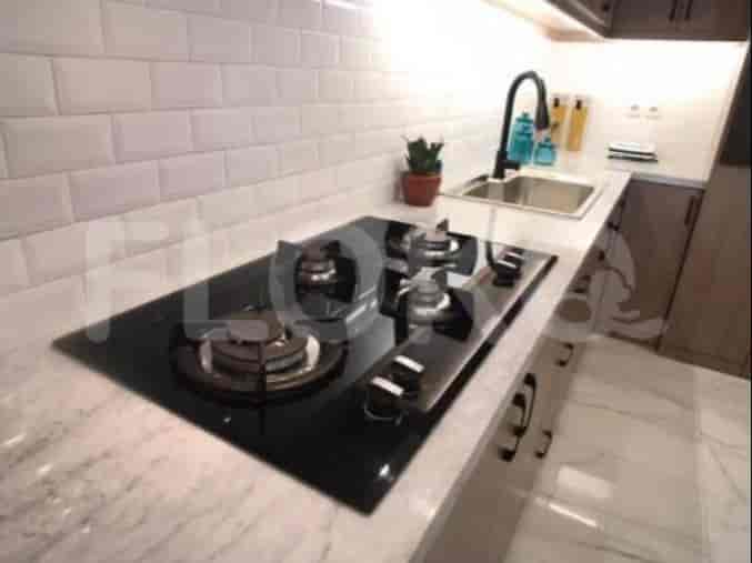 Close-up of kitchen with a gas stove and a sink.