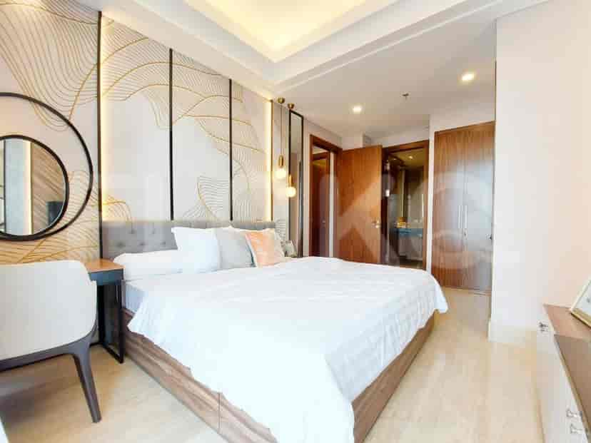 Luxurious bedroom with a large bed, decorative wall panels, and pendant lights.